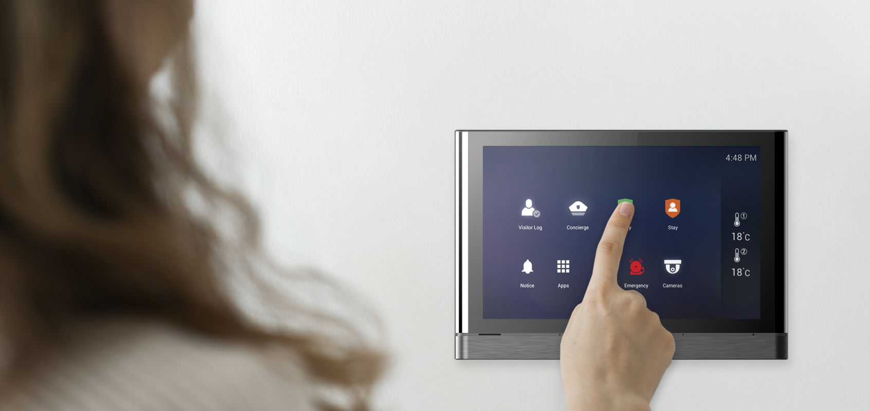 Woman touching SmartONE wall pad screen with her finger