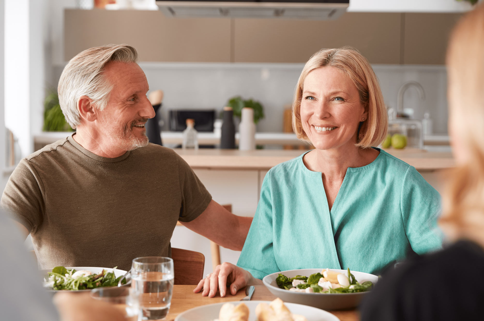 Family with senior parents and adult offspring having lunch together