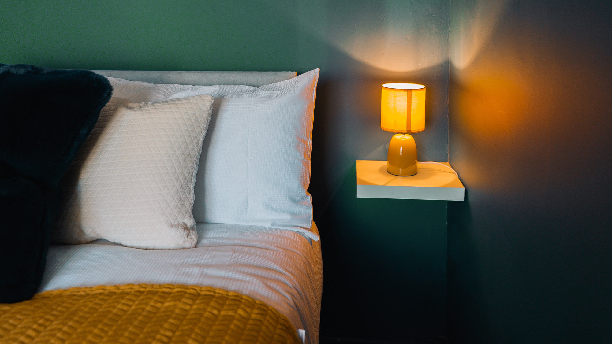 Lamp at bedside emitting orange light