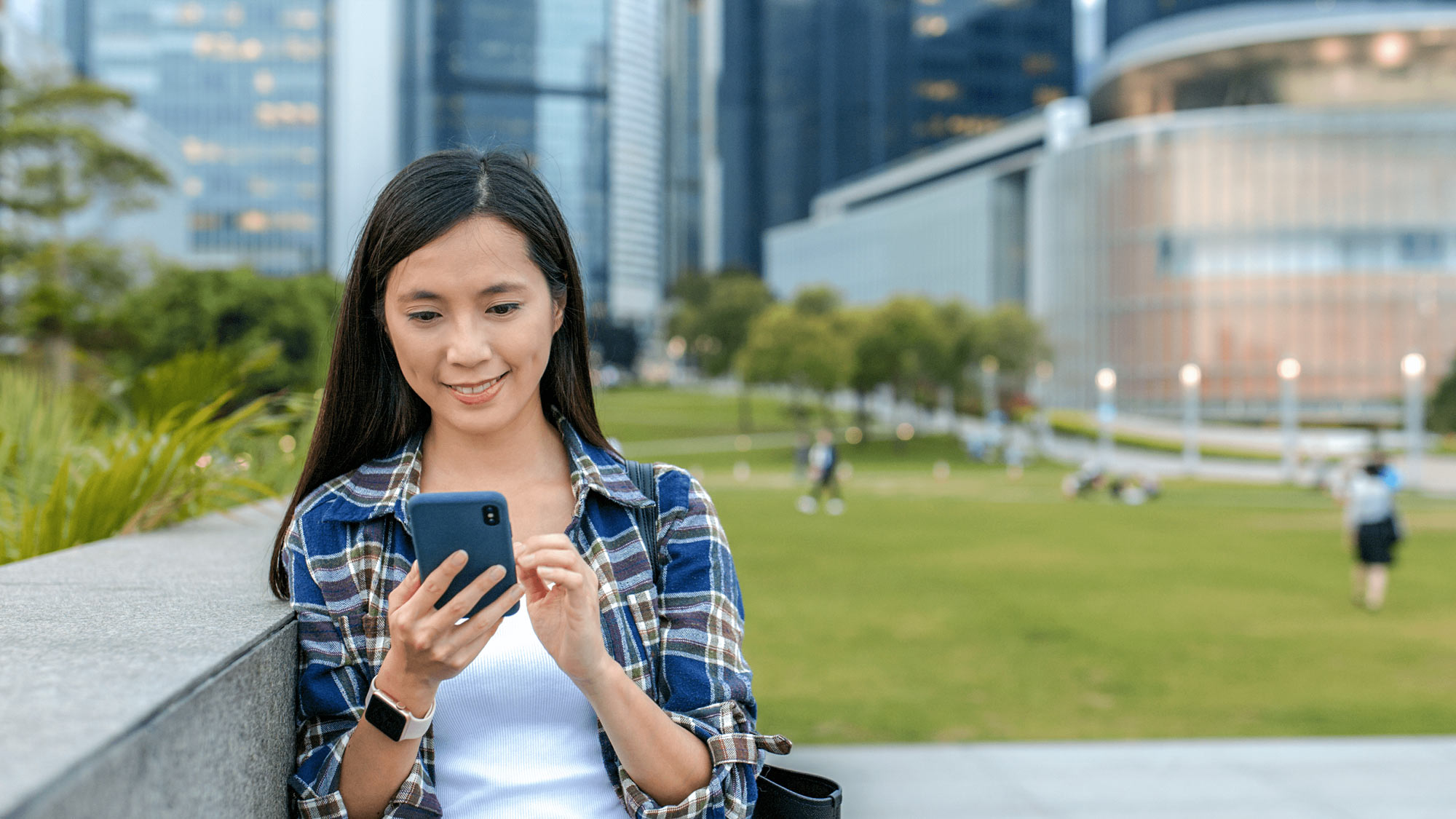 Young woman using her mobile phone outdoors